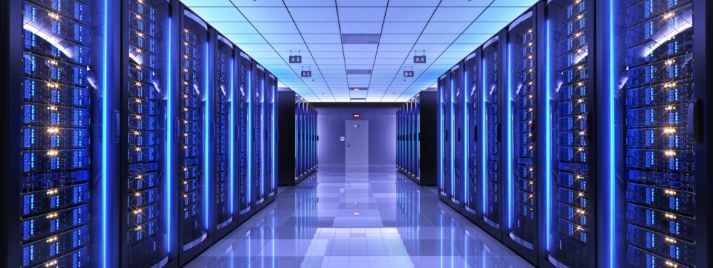 Inside view of a data center with illuminated server racks to illustrate our battery backup units for data centers