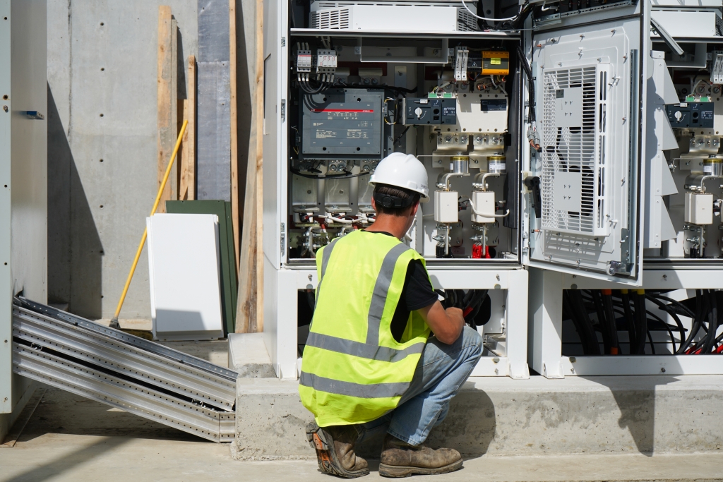 Man working on inverters in a microgrid